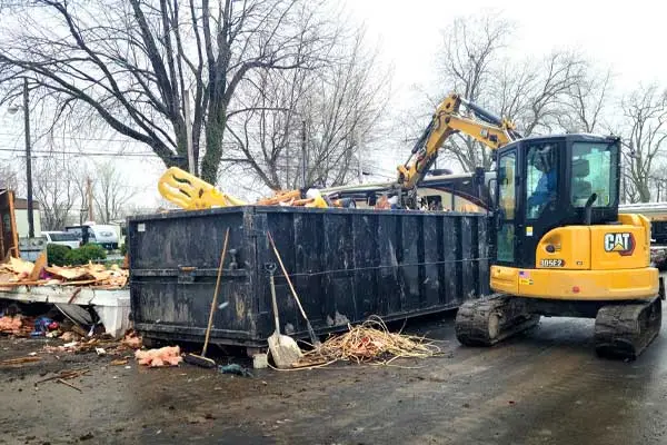 Debris removal with excavator and dumpster